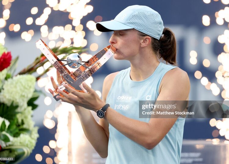 Iga Swiatek of Poland poses with the trophy after defeating Elena Rybaina of Kazakhstan (Photo by Matthew Stockman/Getty Images)