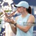Iga Swiatek of Poland poses with the trophy after defeating Elena Rybaina of Kazakhstan (Photo by Matthew Stockman/Getty Images)
