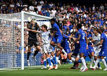 Emiliano Martinez of Chelsea attempts to make a save under pressure from Mats Wieffer of Brighton & Hove Albion during the Premier League 2026/27 match between Chelsea FC and Brighton & Hove Albion at Stamford Bridge on August 30, 2026 in London, England. (Photo by Mike Hewitt/Getty Images)