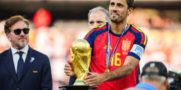 Rodri #9 of Spain picks up the FIFA World Cup Winner’s Trophy after defeating Argentina in the FIFA World Cup 2026 Final at New York New Jersey Stadium on July 19, 2026 in East Rutherford, New Jersey. Spain defeated reigning World Cup champions Argentina, who were led by Lionel Messi, with the lone goal coming from Ferran Torres #7 in the 106th minute of extra time. (Photo by Andrew Harnik/Getty Images)