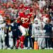 Travis Kelce #87 of the Kansas City Chiefs runs with the ball against the Denver Broncos during an NFL football game (Photo by Michael Owens/Getty Images)