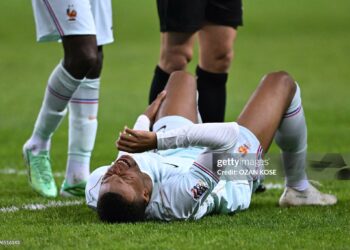 France's forward #10 Kylian Mbappe reacts after scoring the opening goal and to a leg pain during the UEFA Nations League (League A, Group 1) first leg football match between Turkey and France (Photo by OZAN KOSE / AFP via Getty Images)