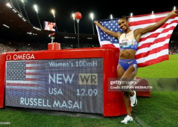 Masai Russell celebrates after winning and breaking the world record in the women's 100m hurdles during the IAAF Diamond League athletics meeting (Photo by Stefan Wermuth / AFP via Getty Images)