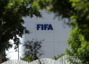 The FIFA logo is seen at its Africa regional office in Sale on August 5, 2026. President Gianni Infantino held emergency talks with other FIFA directors in Morocco on August 5, a source told AFP, amid a wave of criticism over his now shelved plan to open the World Cup to private investment. (Photo by Abdelmajid BZIOUAT / AFP via Getty Images)