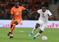 Ivory Coast's forward #19 Nicolas Pépé (L) fights for the ball with Ghana's forward #19 Ernest Nuamah during the Africa Cup of Nations 2027 qualifying football match between Ivory Coast and Ghana at the Stade de Bouake on September 24, 2026. (Photo by Issouf SANOGO / AFP via Getty Images)