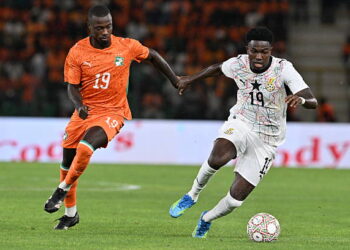 Ivory Coast's forward #19 Nicolas Pépé (L) fights for the ball with Ghana's forward #19 Ernest Nuamah during the Africa Cup of Nations 2027 qualifying football match between Ivory Coast and Ghana at the Stade de Bouake on September 24, 2026. (Photo by Issouf SANOGO / AFP via Getty Images)