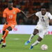 Ivory Coast's forward #19 Nicolas Pépé (L) fights for the ball with Ghana's forward #19 Ernest Nuamah during the Africa Cup of Nations 2027 qualifying football match between Ivory Coast and Ghana at the Stade de Bouake on September 24, 2026. (Photo by Issouf SANOGO / AFP via Getty Images)