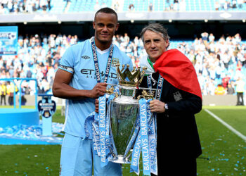 Vincent Kompany the captain of Manchester City and Roberto Mancini the manager of Manchester City pose with the trophy following the Barclays Premier League match between Manchester City and Queens Park Rangers at the Etihad Stadium on May 13, 2012 in Manchester, England. (Photo by Alex Livesey/Getty Images)