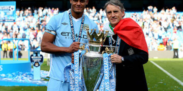 Vincent Kompany the captain of Manchester City and Roberto Mancini the manager of Manchester City pose with the trophy following the Barclays Premier League match between Manchester City and Queens Park Rangers at the Etihad Stadium on May 13, 2012 in Manchester, England.  (Photo by Alex Livesey/Getty Images)