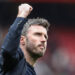 Michael Carrick, manager of Manchester United, celebrates with fans as they chant his name following the 3-2 win during the Premier League match between Manchester United and Liverpool at Old Trafford, Manchester, United Kingdom, on May 3, 2026. (Photo by Mark Cosgrove/News Images/NurPhoto via Getty Images)