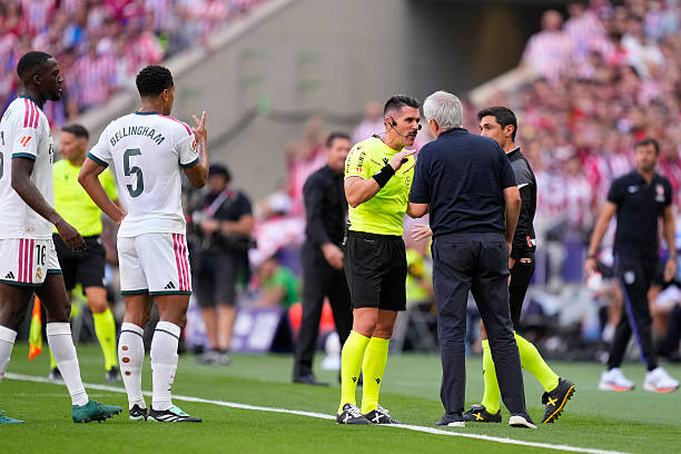 Referee Miguel Ángel Ortiz Arias and Jose Mourinho head coach of Real Madrid talk during the LaLiga EA Sports 2026/27 match between Atletico de Madrid and Real Madrid at Riyadh Air Metropolitano on September 20, 2026 in Madrid, Spain. (Photo by Jose Breton/Pics Action/NurPhoto via Getty Images)