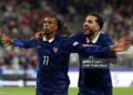 Michael Olise of France celebrates scoring his team’s first goal with teammate Rayan Cherki during the UEFA Nations League 2026/27 group phase match between France and Italy (Photo by Pauline Figuet/Getty Images)