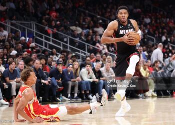 Dyson Daniels #5 of the Atlanta Hawks falls to the floor as Giannis Antetokounmpo #7 of the Miami Heat drives to the basket during the second quarter (Photo by Kevin C. Cox/Getty Images)