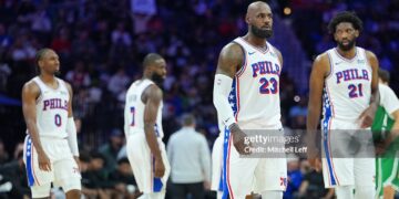 LeBron James #23, Joel Embiid #21, Jaylen Brown #7, and Tyrese Maxey #0 of the Philadelphia 76ers look on against the Boston Celtics (Photo by Mitchell Leff/Getty Images)