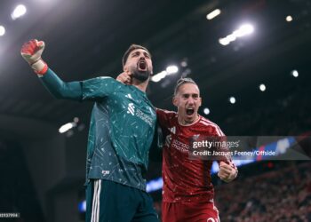 Liverpool goalkeeper Giorgi Mamardashvili celebrates victory with Kostas Tsimikas of Liverpool during the Carabao Cup Fourth Round match between Liverpool and Chelsea (Photo by Jacques Feeney/Offside/Offside via Getty Images)
