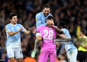 Rayan Cherki, Geronimo Rulli and Jeremy Doku of Manchester City celebrate winning the penalty shootout agter the Carabao Cup Fourth Round match between Manchester City and Brighton & Hove Albion (Photo by Jan Kruger/Getty Images)