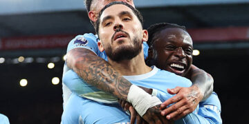 Rayan Cherki of Manchester City celebrates scoring their third goal with Jeremy Doku, Enzo Fernandez during the Premier League 2026/27 match between Liverpool FC and Manchester City at Anfield on October 11, 2026 in Liverpool, England. (Photo by Robbie Jay Barratt - AMA/Getty Images)