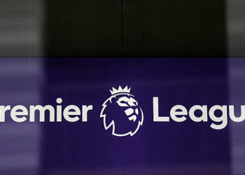 The logo is pictured through a glass window at the headquarters of the English Premier League in London on March 13, 2020. The English Premier League suspended all fixtures until April 4 on Friday after Arsenal manager Mikel Arteta and Chelsea winger Callum Hudson-Odoi tested positive for coronavirus. (Photo by Isabel Infantes / AFP via Getty Images)