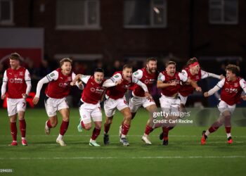 Fleetwood Town players celebrate after Jay Lynch of Fleetwood Town saves a penalty from Bruno Guimaraes of Arsenal to win the match during the Carabao Cup Fourth Round match between Fleetwood Town and Arsenal (Photo by Carl Recine/Getty Images)
