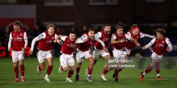 Fleetwood Town players celebrate after Jay Lynch of Fleetwood Town saves a penalty from Bruno Guimaraes of Arsenal to win the match during the Carabao Cup Fourth Round match between Fleetwood Town and Arsenal (Photo by Carl Recine/Getty Images)