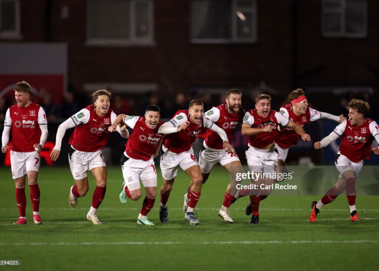 Fleetwood Town players celebrate after Jay Lynch of Fleetwood Town saves a penalty from Bruno Guimaraes of Arsenal to win the match during the Carabao Cup Fourth Round match between Fleetwood Town and Arsenal (Photo by Carl Recine/Getty Images)
